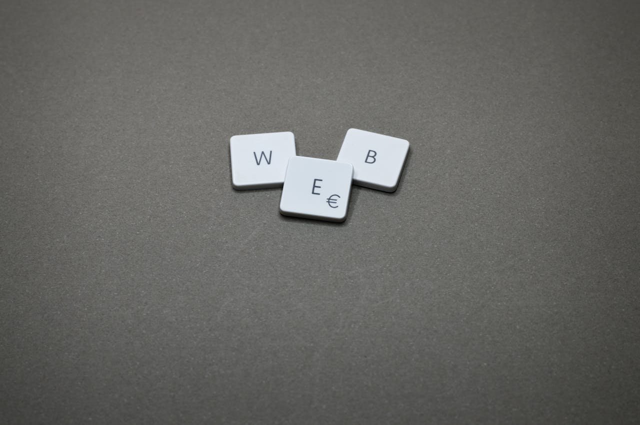 Minimalist image of keyboard keys spelling WEB on a plain background.